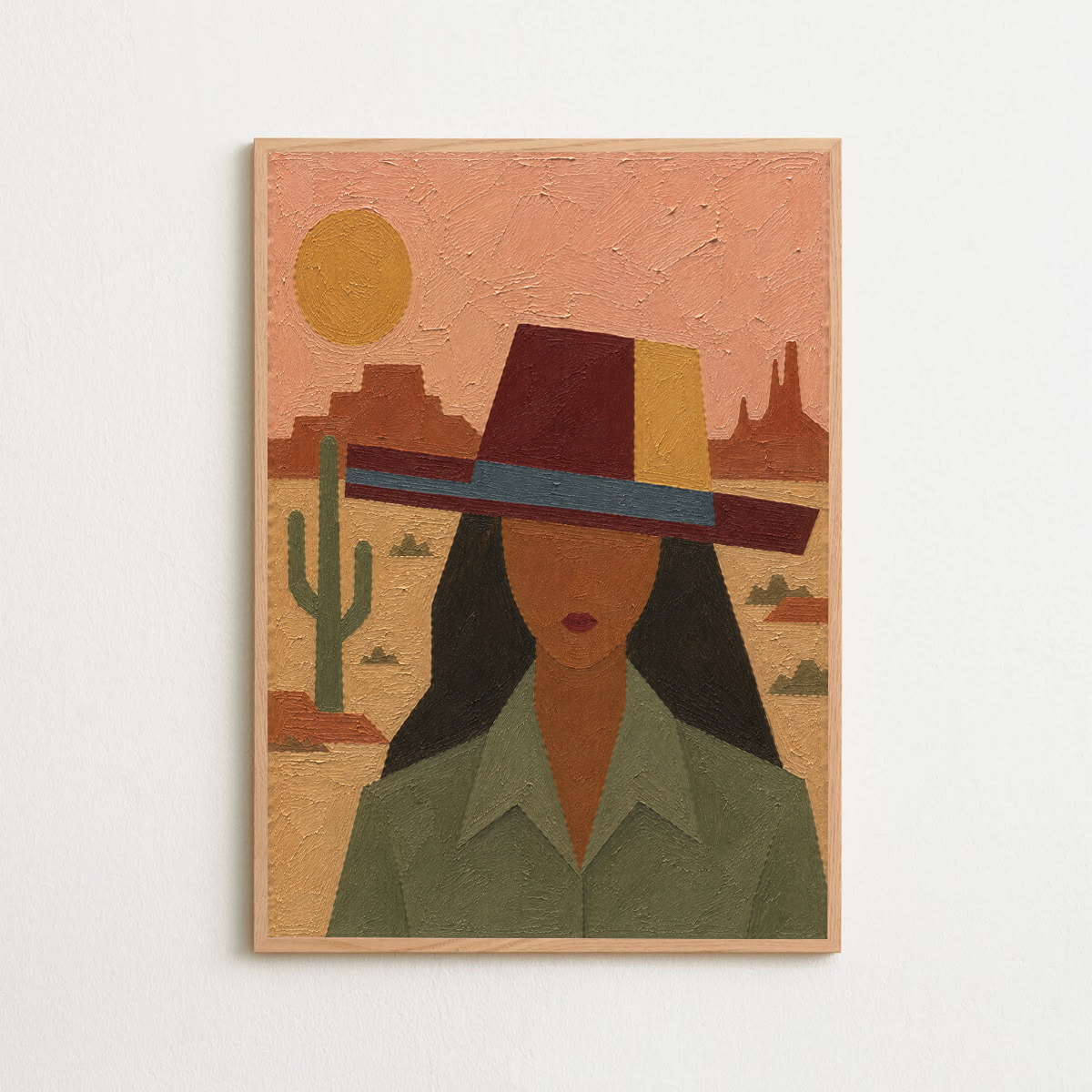 A framed textured art print featuring a stylized desert portrait of a woman 