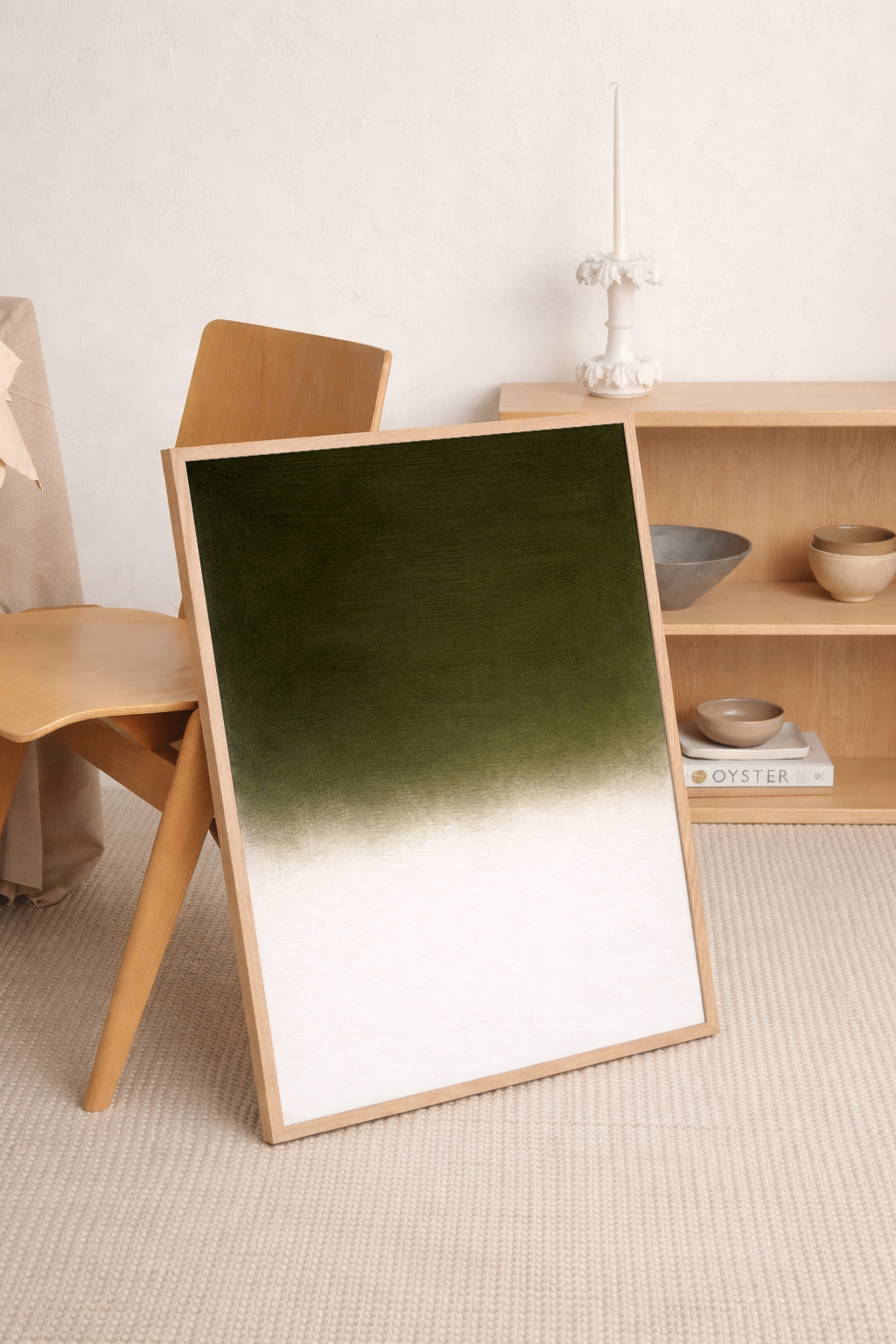 Green gradient mirror with wooden frame on a light-colored floor
