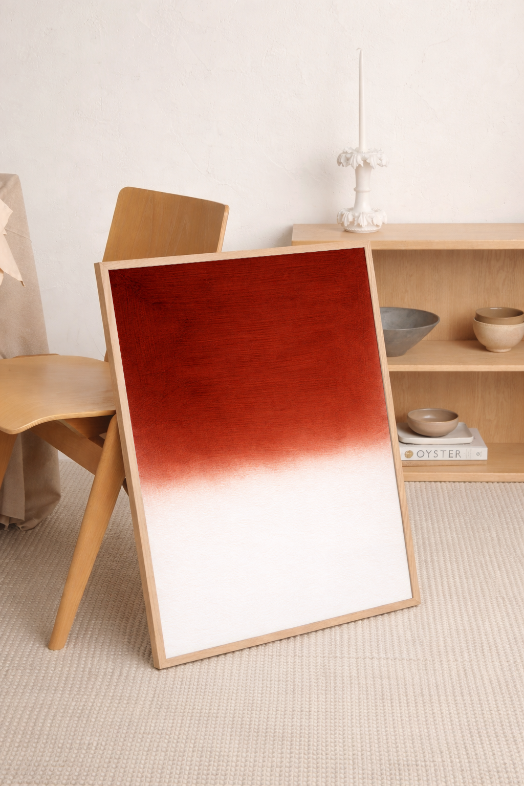Framed artwork with a gradient from red to white on a wooden floor.