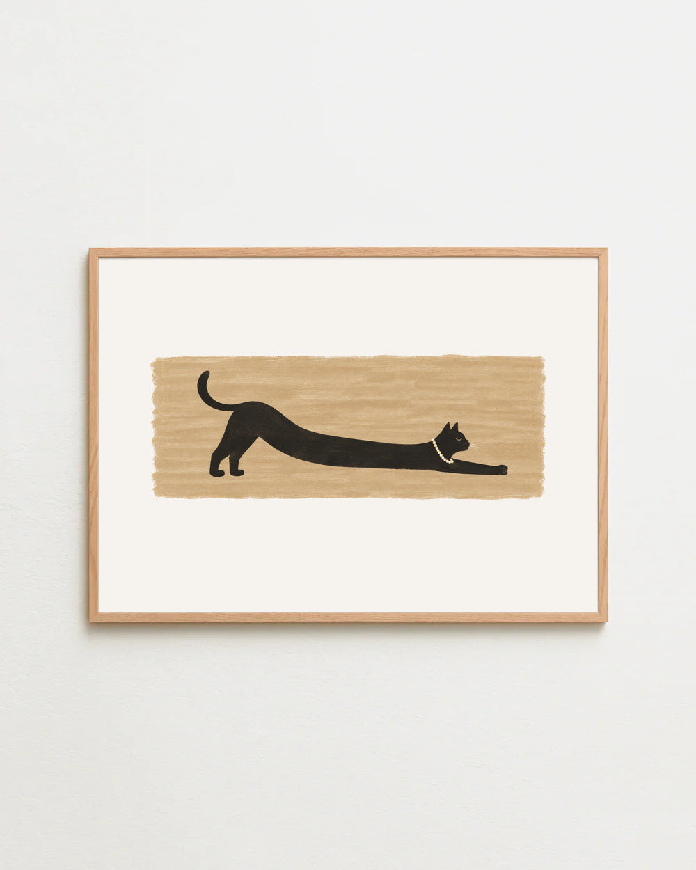 the long stretch, a long black cat in pearls on warm sand, in a wooden frame